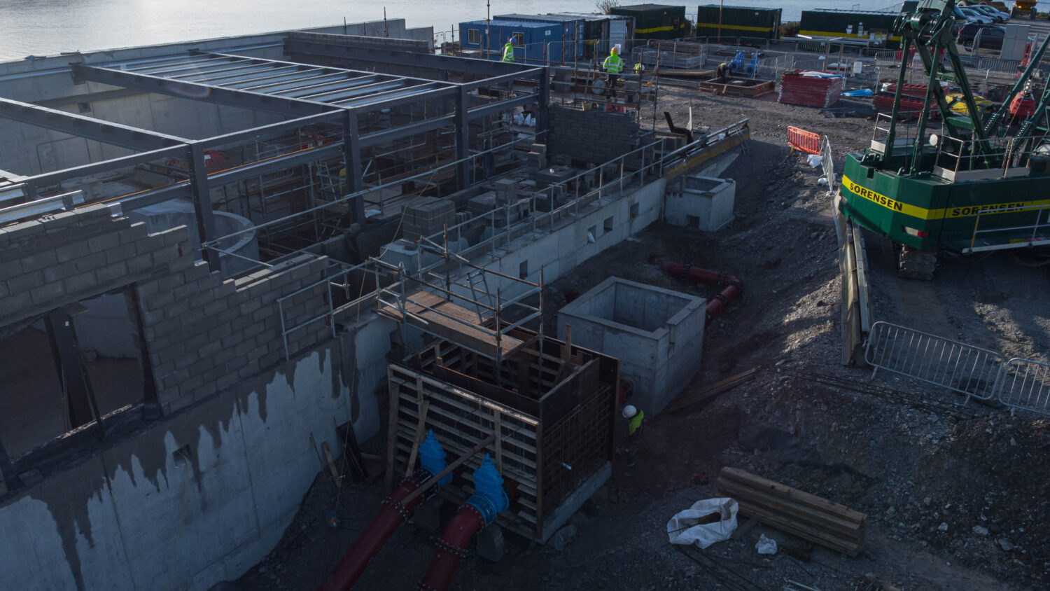 drone shot of concrete walls and structures in a water treatment plant 