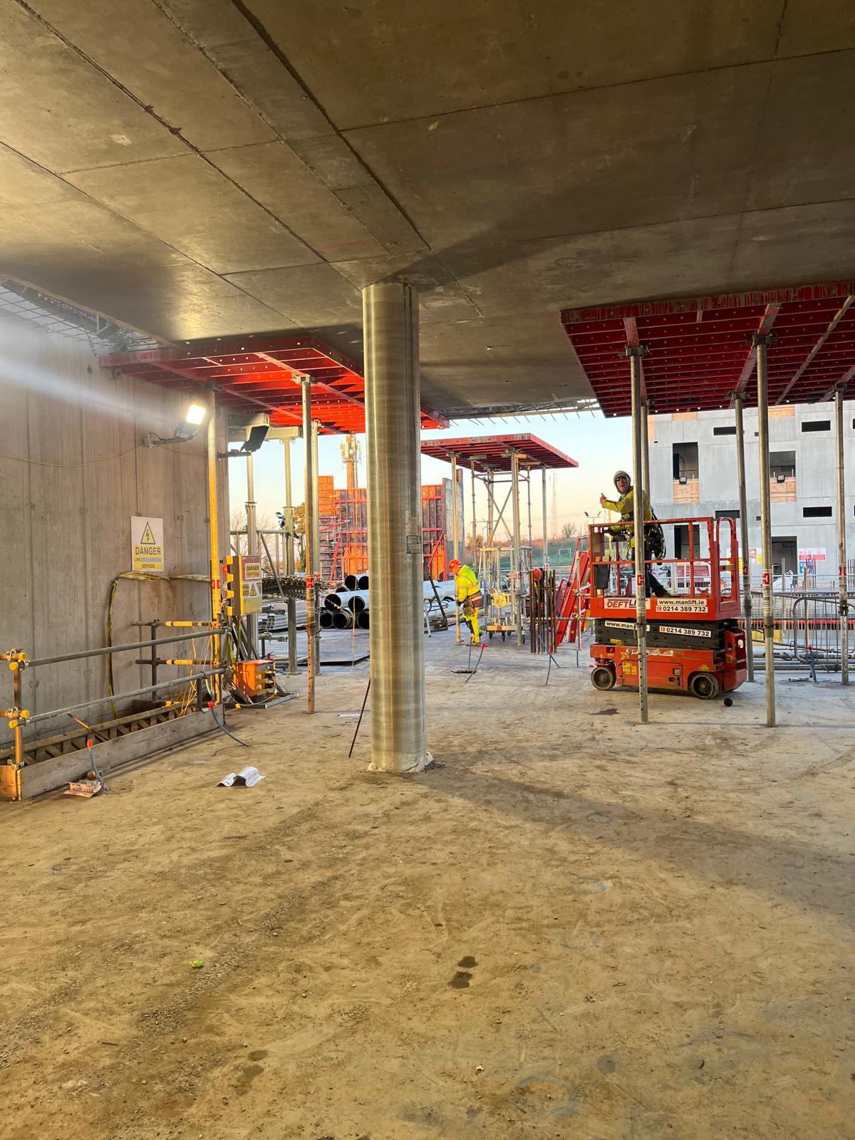 worker on a platform giving a thumbs up during construction of a tech company building