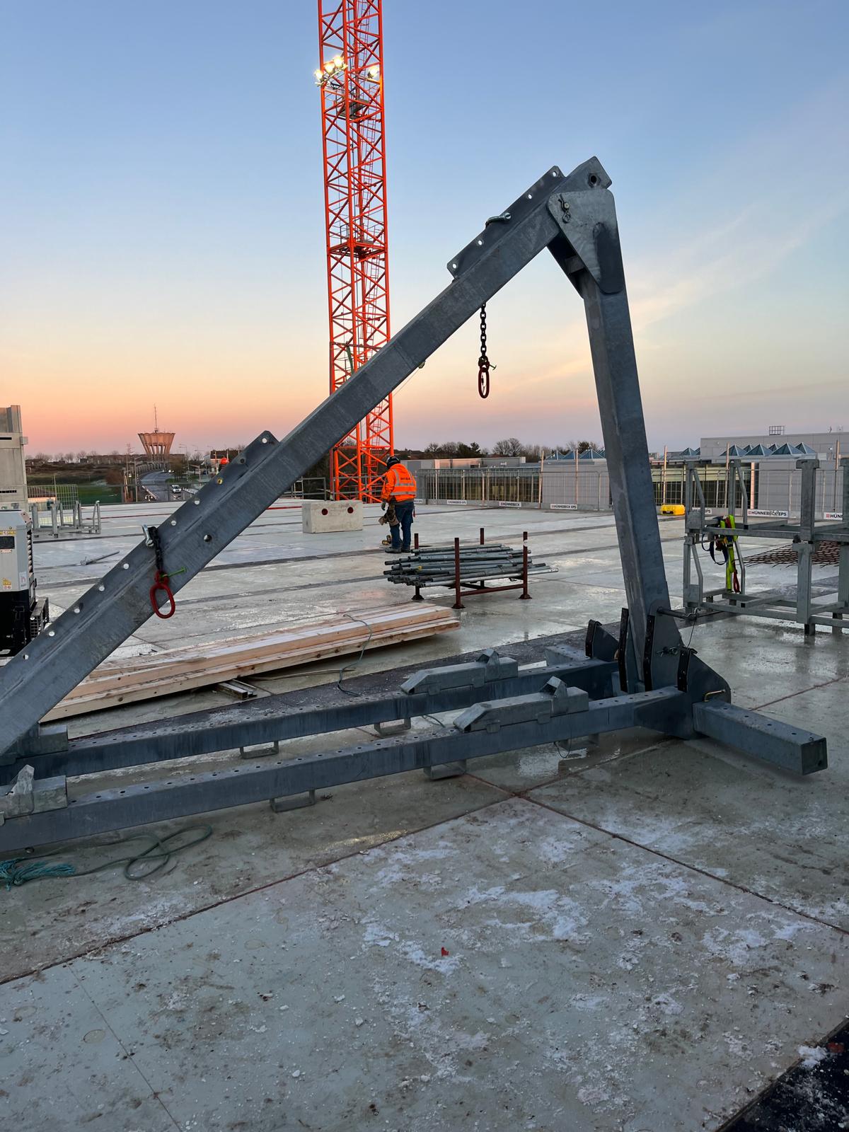 worker standing on the concrete roof of a tech company building