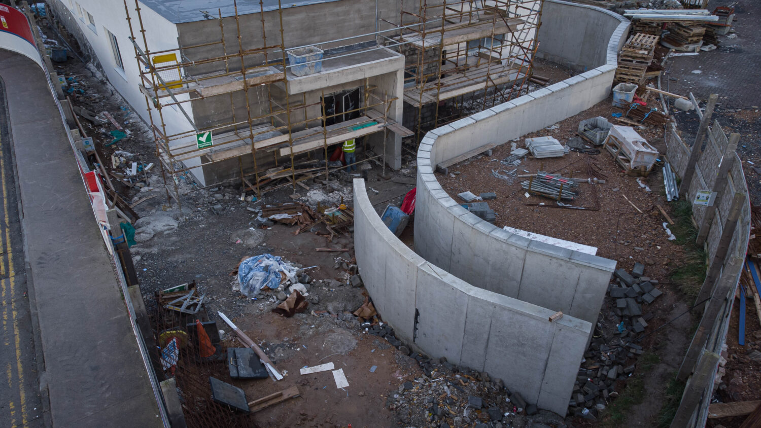 workers on scaffolding working on concrete forms
