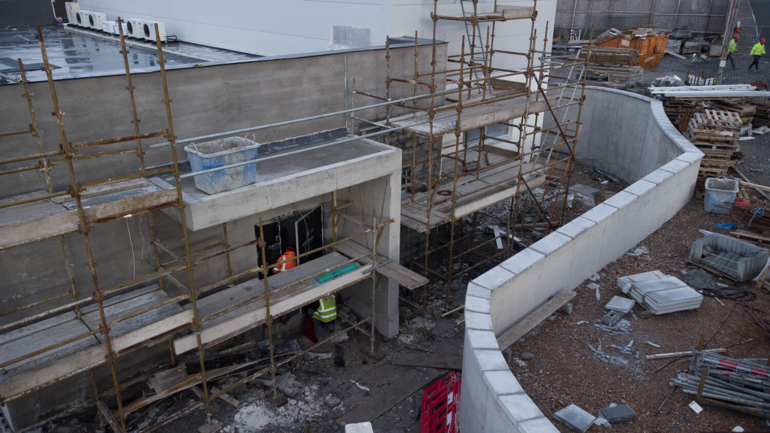 workers on scaffolding working on concrete forms